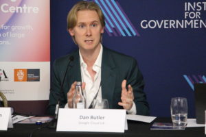 Dan Butler from Google Cloud UK speaking while Prof. Mark Thompson listens during the event.