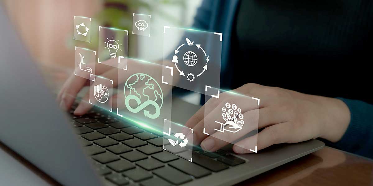 A person typing on a laptop with floating digital icons representing sustainability concepts such as recycling, renewable energy, and environmental responsibility, overlayed in a futuristic design. Credit: Shutterstock